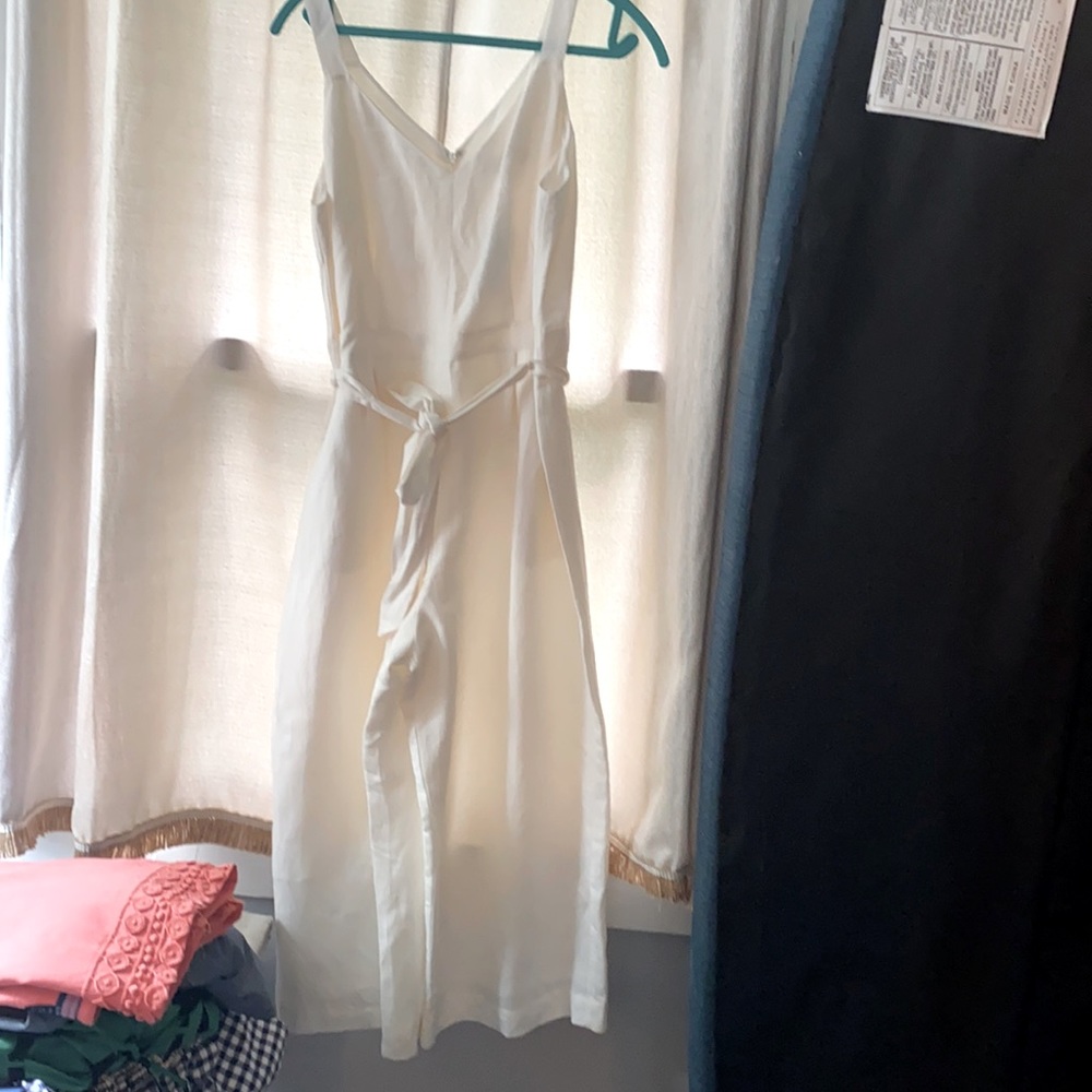 White lined jumpsuit. Wide leg